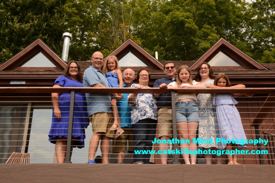 Photo of a family posed on a deck 